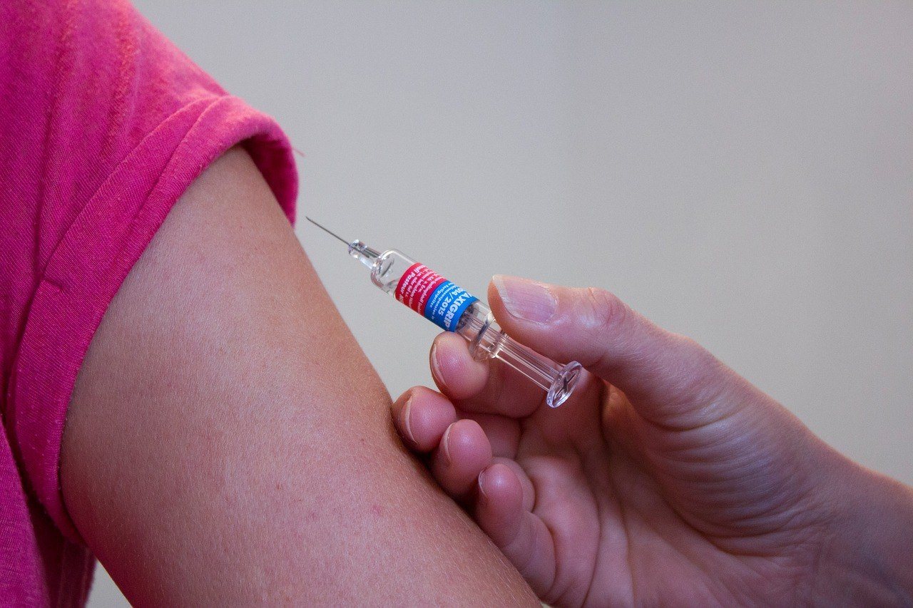 Vaccination arm with syringe